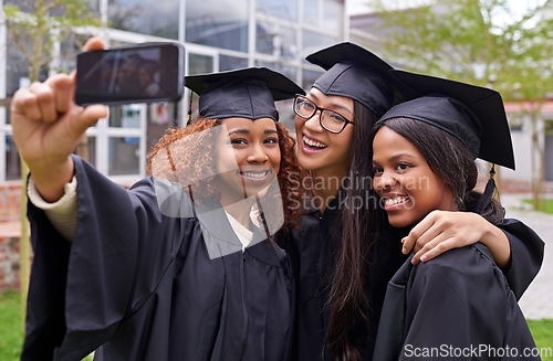 Image of Education, women celebrating graduation with selfie and group at the ceremony outside on campus. University or college academic achievement, female students take photo and people dressed in cloaks