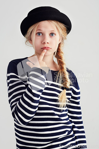 Image of Serious, confused and portrait of a girl with fashion isolated on a white background in studio. Doubt, confusion and a young child looking puzzled in fashionable, stylish and trendy clothes for youth