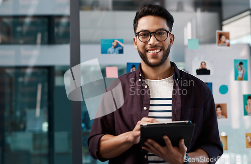 Image of Technology, portrait of happy businessman with tablet and standing in office at work. Social media or networking, Corporate and creative young man with mobile device checking emails at workplace