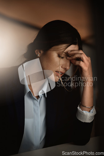 Image of Tired, headache and business woman in pain at night for career migraine, burnout and mental health risk or depression. Depressed, anxiety or person with mistake stress, frustrated or fatigue problem