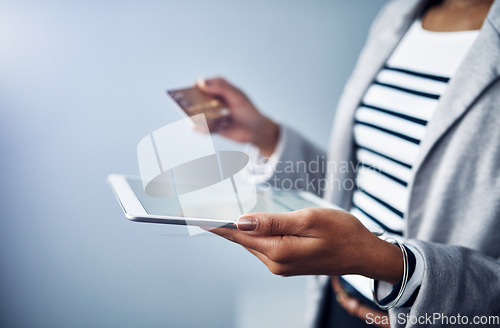 Image of Woman, tablet in hands with credit card and online shopping, ecommerce and fintech on studio background. Digital payment, finance and professional female person with internet banking and connectivity