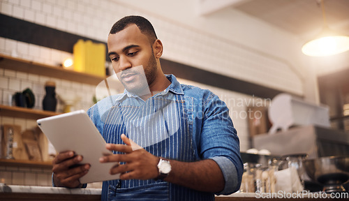 Image of Focus, tablet and manager with man in cafe for online, entrepreneurship and startup. Waiter, technology and food industry with small business owner in restaurant for barista, african and coffee shop