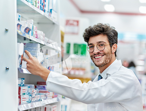 Image of Pharmacist, medicine and portrait of a man working in a pharmacy store for retail career with a smile. Male person in pharmaceutical or medical industry for service, healthcare and inventory on shelf