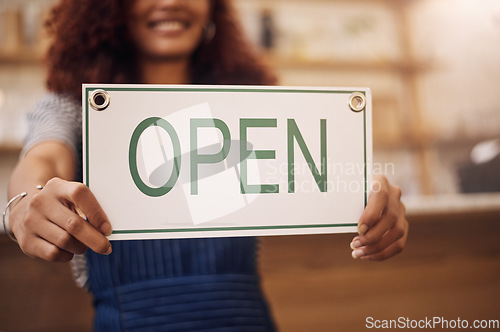 Image of Open sign, hands and woman in small business, store and advertising news of retail shopping time, banner and trading information. Closeup, shop owner and board for opening, welcome and cafe signage