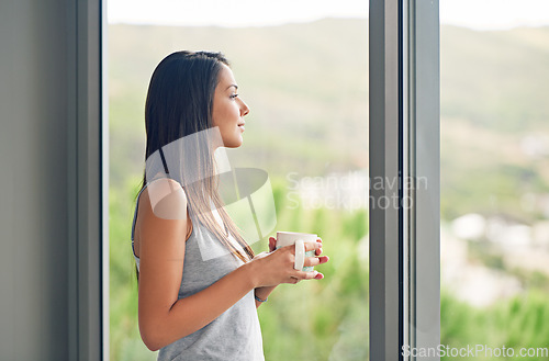 Image of Window, view and woman with a coffee, morning and thinking at home, relax and ideas. Female person, model and happy girl with tea, glass and lady with wellness, thoughts and start day in an apartment