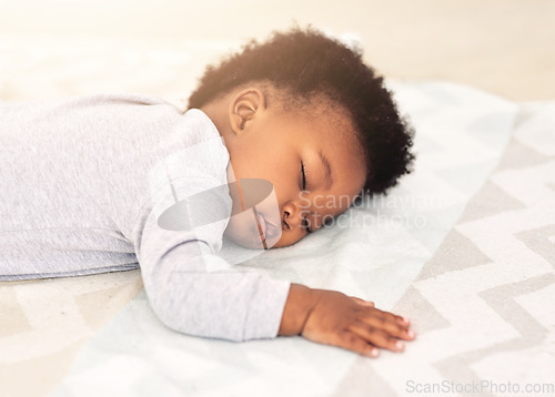 Image of Baby, african boy and sleeping on bed for rest, health and peace for growth, development and relax in family home. Black male infant, tired and sleep in bedroom with fatigue, quiet and calm in house