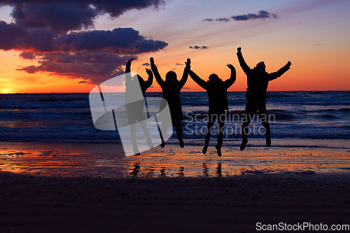 Image of Sunset, beach and silhouette of jumping friends in nature, freedom and celebrating travel outdoor. Shadow, jump and group of people at the ocean at sunrise for adventure, celebration or sea vacation