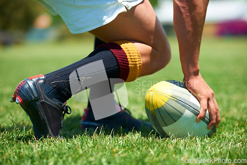 Image of Hand, rugby and ball with a sports man playing a game on a grass field for competition or recreation. Fitness, training and health with a male athlete getting ready to play a match outdoor in summer