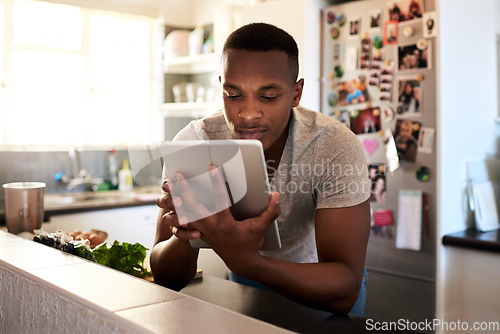 Image of Search, cooking and tablet with black man in kitchen for website, food and breakfast blog. Internet, technology and health with person reading online at home for nutrition, digital and morning