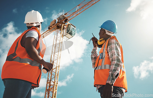 Image of Engineering, construction and team with walkie talkie and crane for building project, teamwork or communication. Black woman and man manager outdoor for engineer planning or safety inspection