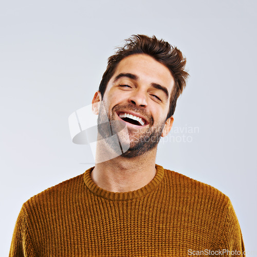 Image of Laughing, comedy and portrait of happy man by white background. Smile, confident and face laugh of comic person, isolated and young male model enjoying a comedy joke on a studio backdrop