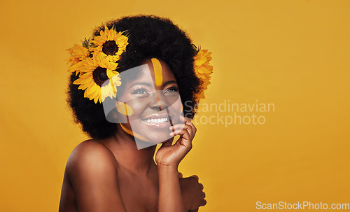 Image of Sunflower, beauty and happy black woman in studio for makeup, wellness and treatment on yellow background. Flower, skincare and African female model smile, relax and pose with natural skin cosmetics