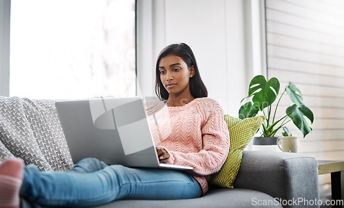 Image of Relax, home and woman on a couch, laptop and typing with connection, search internet and online reading. Female person, pc and lady on a sofa, technology and chilling with a movie in the living room