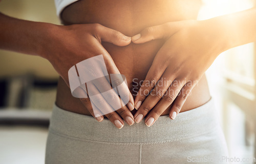 Image of Hands of woman on stomach, diet and fitness for gut health and lipo wellness for body positivity. Gym, healthcare and tummy tuck, girl model with heart hand sign on abdomen for muscle exercise goals.