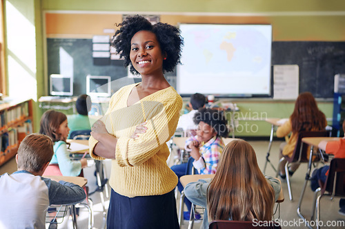 Image of Portrait, black woman and teacher with arms crossed, students or happiness in a classroom. Face, female educator or employee with children, smile or education with knowledge, learners and development