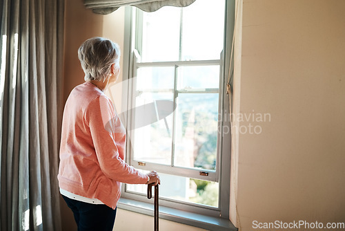 Image of Senior woman, nursing home and window for thinking, vision or ideas with walking stick, disability or rehabilitation. Elderly lady, remember or looking ahead in retirement, house or memory in morning