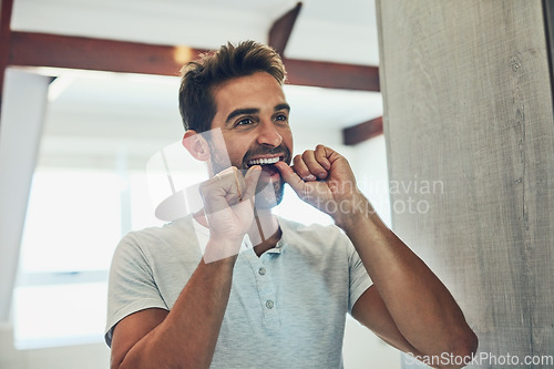 Image of Dental, floss and teeth with man in bathroom mirror for cleaning, morning routine and oral hygiene. Smile, cosmetics and health with male person flossing at home for self care, breath and mouth