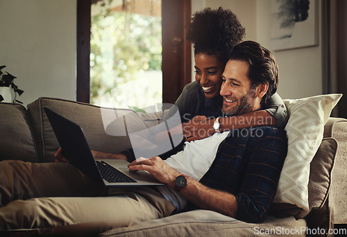 Image of Laptop, subscription and an interracial couple watching a movie using an online streaming service for entertainment. Computer, relax or internet with a man and woman bonding together over a video