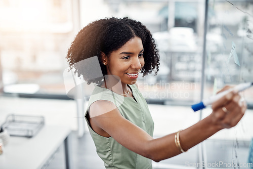 Image of Business, glass wall and black woman writing, planning or strategy in office. Brainstorming, board and happy female person write, working on project and schedule, notes or information in workplace.