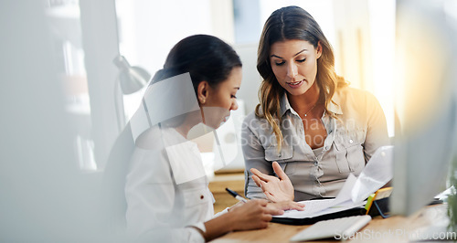 Image of Business woman, notebook and partnership with discussion, planning or paperwork in office together. Women, teamwork and talking with documents, notes or schedule in workplace for collaboration at job