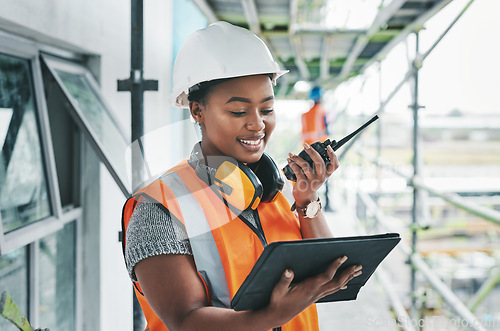 Image of Tablet, engineer and black woman worker planning on a construction site strategy and talking on a walkie talkie. Project management, infrastructure and female contractor doing building assessment