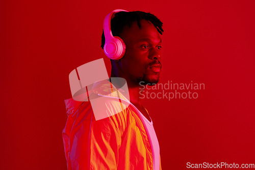 Image of Headphones, fashion and black man profile with music and online song streaming. Internet radio, web audio and African male model with red background in a studio with gen z style and neon lighting