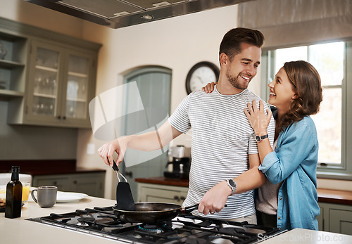 Image of Happy, food and cooking with couple in kitchen and hugging for breakfast, morning and happiness. Smile, care and nutrition with man and woman eating at home for love, health and hungry together