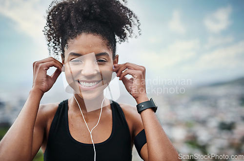 Image of Fitness, earphones and portrait of woman outdoor with music for training, running or cardio. Radio, smile and face of African female runner with podcast for workout motivation, exercise and sport run