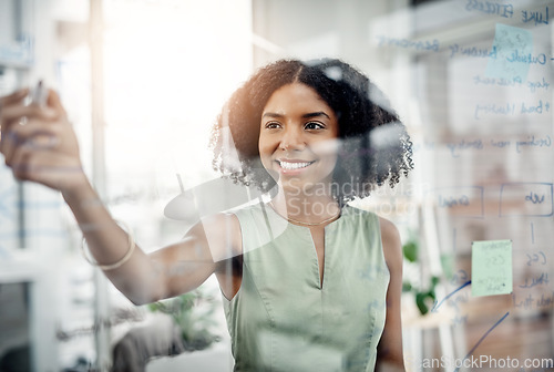 Image of Business, glass wall and black woman writing, strategy or brainstorming in office. Planning, board and happy female person write, working on project and schedule, notes or information in workplace.