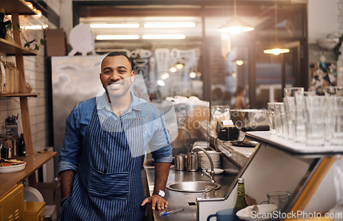 Image of Coffee shop, restaurant and happy portrait of man for service, working and welcome in cafe. Small business owner, bistro startup and male worker, waiter of barista smile by counter ready to serve