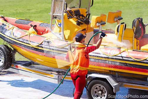 Image of Cleaning, boat and rescue or emergency worker washing speedboat ready for search mission for an investigation. Safety, person or man coast guard employee in preparation for water service