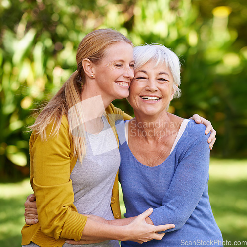 Image of A mother with adult daughter hug outdoor, happiness and spending quality time in garden or park together. Family, happy women are caring in relationship with love, bonding and carefree in nature
