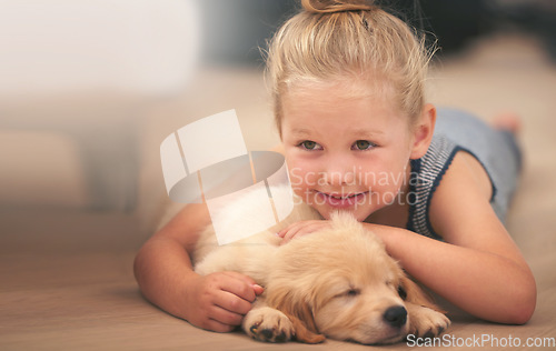 Image of Young girl hug her puppy, relax at home and happy with sleeping golden retriever dog and child with smile. Happiness, pet care and love with female kid with her domestic animal lying on wood floor