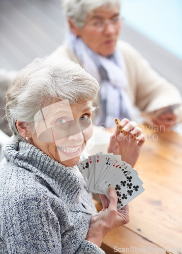 Image of Happy, portrait and old people playing cards at a nursing home for happiness, recreation and game. Smile, showing and a senior woman with a win in poker, excited and bonding with friends in games