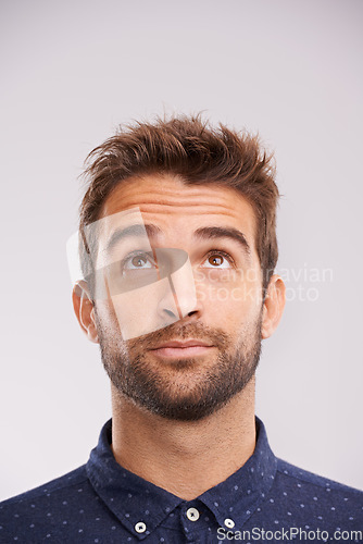 Image of Thinking, looking up and man in studio with solution, ideas and relax with eyes and mockup. Isolated, gray background and male model face think and distracted with planning with decision alone