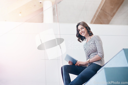 Image of Tablet, portrait and businesswoman on the stairs in the office doing research for corporate project. Happy, smile and professional female employee working on company report with mobile in workplace.