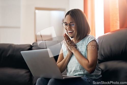 Image of Home, excited and woman with a laptop, couch and happiness with website launch, connection and joy. Female person, girl or freelancer on a sofa, pc or technology with announcement, internet and email