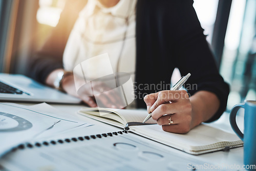 Image of Business woman, hands and writing in a office with planning notes and corporate notebook. Female person, employee and work planner book with company paperwork and charts for professional project