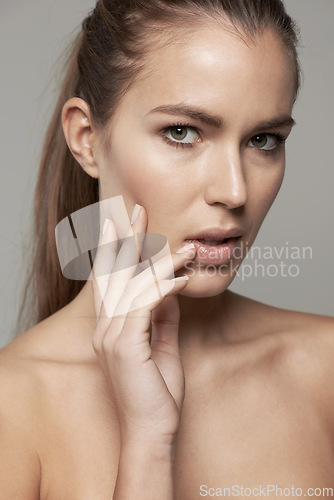 Image of Skincare, beauty and portrait of woman in studio for wellness, facial treatment and self care. Dermatology, spa and face of female person with natural cosmetics, makeup and glow on gray background