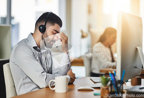 Image of Headache, stress or tired man in call center with burnout, head pain or overworked in crm communication. Migraine, office or telemarketing sales agent frustrated with anxiety, fatigue or problems