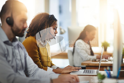 Image of Communication, coworking or woman in call center consulting or typing on laptop at customer services. Virtual assistant, girl or female sales consultant in telemarketing or telecom company help desk