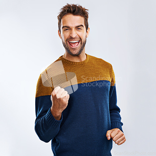 Image of Portrait, cheering and man excited, celebration and winning with guy isolated against a studio background. Face, male and happy person with fist, winner and excitement with happiness and victory