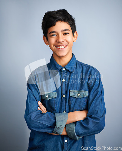 Image of Smile, happy and portrait of teenager with fashion feeling confident arms crossed isolated in a gray studio background. Content, happiness and young Arab teen male person or teen with style