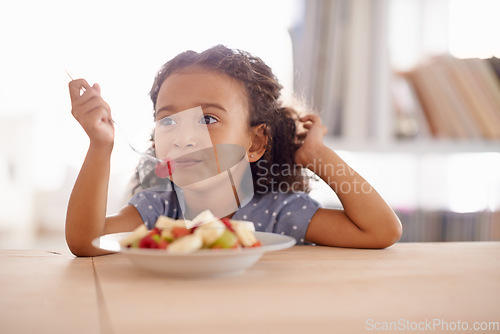 Image of Eating child, breakfast and fruit salad at home with happiness and wellness meal with a smile. House, nutrition and young girl with healthy food and fruits of a hungry kid in the morning at a table