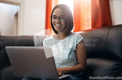 Image of Home, smile and woman with a laptop, couch and typing with connection, network and online reading. Female person, freelancer and entrepreneur with pc, technology and lady search internet and website