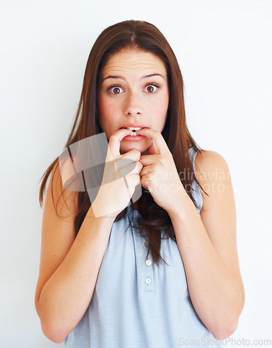 Image of Portrait, nervous and biting nails with a woman in studio isolated on a white background for psychology. Stress, anxiety and mental health with a scared young female person looking terrified in fear