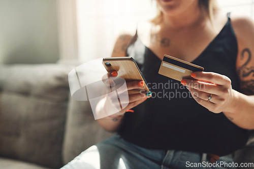 Image of Phone, credit card and woman hands on sofa for online shopping, e commerce and fintech payment, loan or finance. Person on couch typing banking information on mobile app for home and web transaction