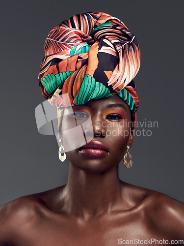 Image of Portrait, head wrap and black woman with beauty, makeup and confident model on a grey studio background. Face, female person and girl with traditional turban, cosmetics and fashion with elegance