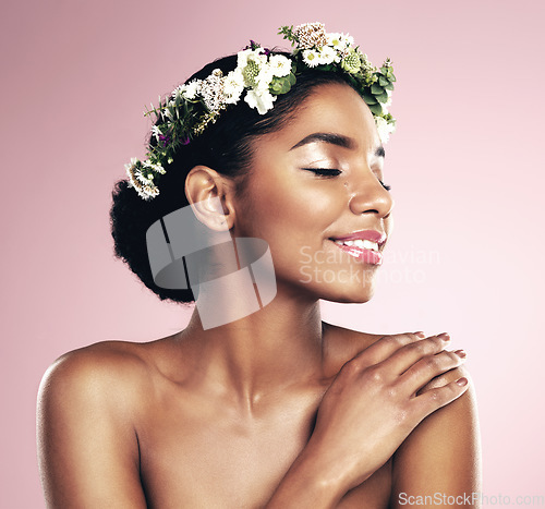 Image of Happy woman, crown of flowers and makeup in studio, pink background and natural skincare aesthetic. African face, female model and floral headband for beauty, sustainable cosmetics and spring fashion