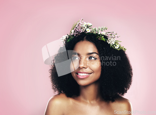 Image of Woman, thinking and flower crown for beauty in studio, pink background and mockup of natural hair or skincare. Face, happy african model and daydream with floral wreath for sustainable cosmetic ideas